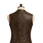 Brown sleeveless pirate-inspired leather vest with lapel collar, button front, flap pockets, stitched panels, and shaped waist