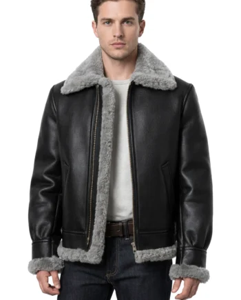 Black Leon Kennedy-inspired shearling jacket with gray fur collar, front zipper, cuff trim, hand pockets, and structured waist-length shape