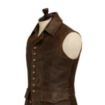 Brown sleeveless pirate-inspired leather vest with lapel collar, button front, flap pockets, stitched panels, and shaped waist