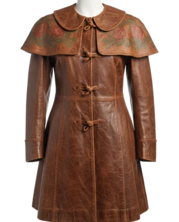 Brown women's medieval-inspired coat with floral capelet, long sleeves, flared panels, rounded collar, and visible side pocket